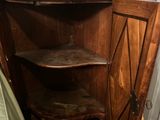 a wooden cabinet with a shelf in the middle of it
