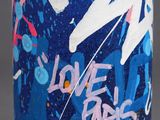 a close up of a can with graffiti on it sitting on a table