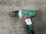 a cordless drill that is laying on the ground