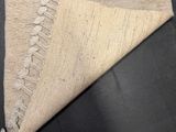 a close up of a rug with a piece of fabric on top of it