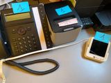 a telephone and a cell phone sitting on a desk