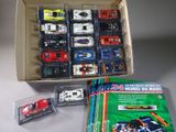 a box of assorted toy cars on a table