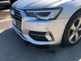 the front end of a silver audi parked in a parking lot