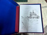 someone is drawing a picture of a castle in a book