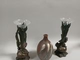 three vases sitting next to each other on a table