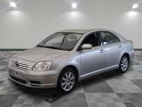 a silver car parked in a room with checkered floor