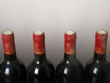 four bottles of wine are lined up on a table