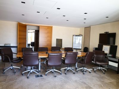 a conference room with a table and chairs in it