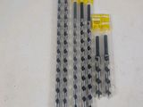 a set of five drill bits are sitting on a table