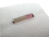 an image of a pink and white crystal stone on a white cloth