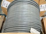 a large roll of gray electrical wire on a pallet