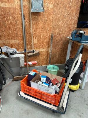 a small cart with a lot of items in it on the floor