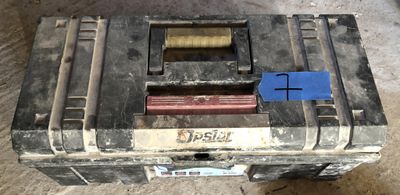 a close up of a tool box with a blue tag on it