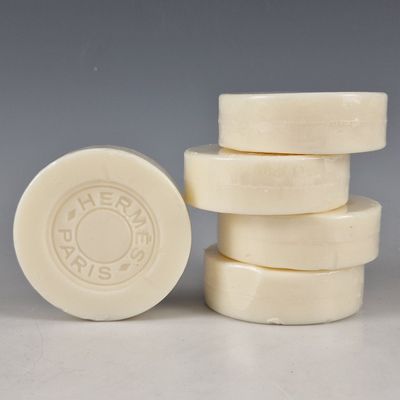quatre pains de savon blancs empilés les uns sur les autres sur une table