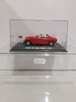 an old model of a red sports car in a glass display case