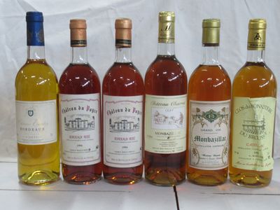 Plusieurs bouteilles de différents types de vin sont alignées sur une table