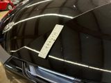 a sticker on the hood of a car with a price tag on it