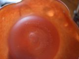 a close up view of a red bowl with a hole in it