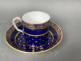 a close up of a cup and saucer on a table