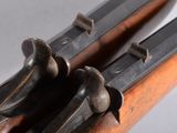 an image of a close up of a rifle on a table