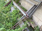 a pile of old metal and wood on the side of a building