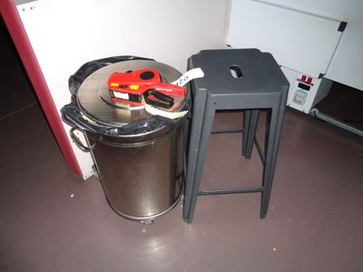 a trash can and a stool in the corner of a room
