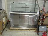 a refrigerator in the middle of a pallet in a warehouse