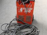 a machine that is sitting on the ground next to a bunch of wires