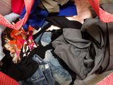 a red bag full of clothes and a pair of jeans