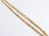 a gold necklace with a chain that has been made from a single strand of gold chain