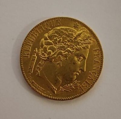 a close up of a gold coin on a white surface