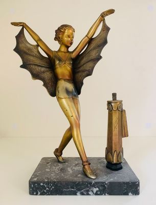 statue of a woman with wings and a suitcase on a marble base