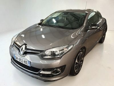 the grey car is parked in the white room
