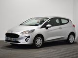 a white ford fiesta parked in a room with a checkered floor