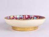 a close up of a bowl on a white surface
