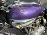 a purple motorcycle parked on the side of the road