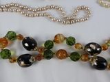 a close up of a necklace with beads on a table
