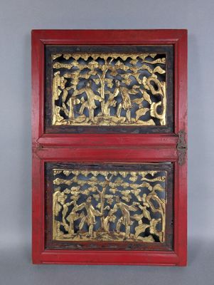 two red and gold boxes with carvings on them sitting on a table