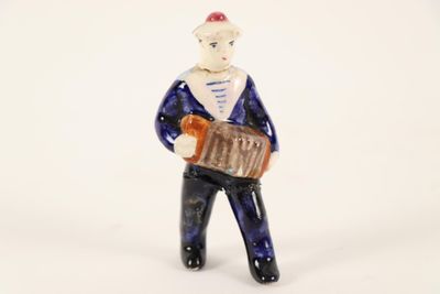 a small figurine of a man with a suitcase