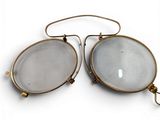 pair of antique brass and glass eyeglasses on a white background