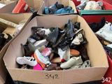 a box full of shoes that are sitting on the ground