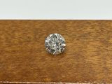 a close up of a diamond on a wooden table