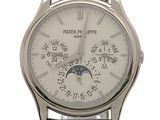 a silver watch with a white dial on a black strap