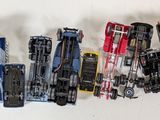 a lot of toy cars that are lined up on a table