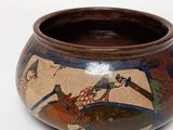 a small bowl with a painting on it