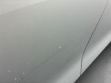 a close up of a car ' s paint job on the side of the car