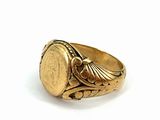 an image of a gold ring with a coin in the center