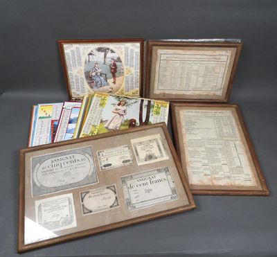 several framed and unframed items are on display on a table