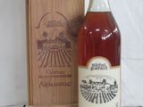 a bottle of wine sitting next to a wooden box