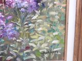 a painting of a bunch of purple flowers in a frame